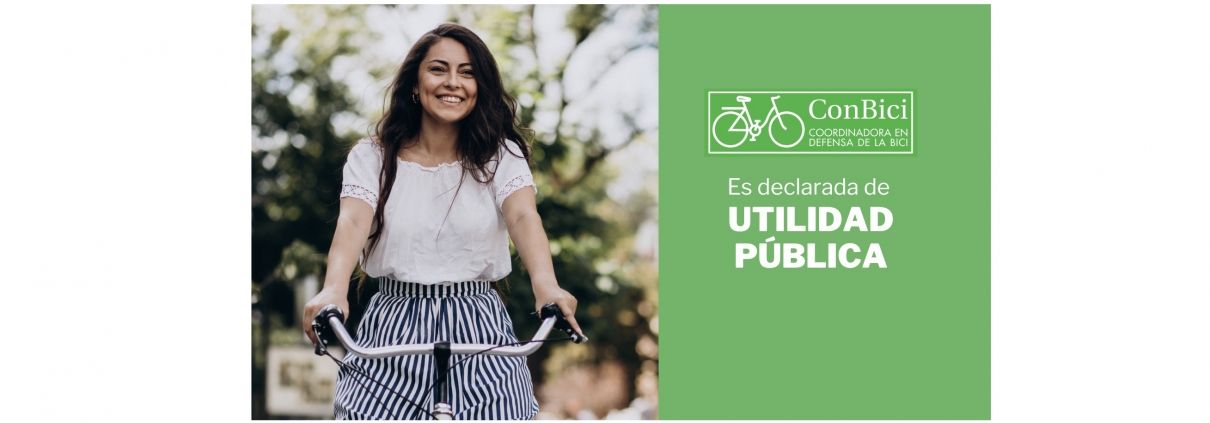 Mujer en bicicleta. Rótulo CONBICI DECLARADA DE UTILIDAD PÚBLICA